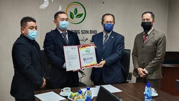 Zailan (dua,kanan) dan Dr Mohd Zainizan (dua,kiri) bertukar dokumen perjanjian yang ditandatangani pada majlis di pejabat KDMI di Kuantan pada Jumaat.