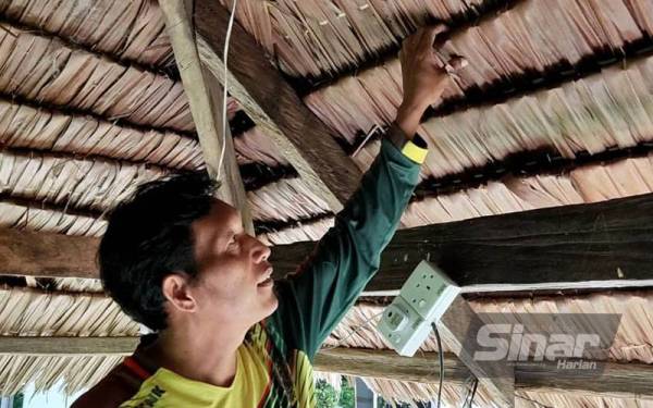Mat Isa menunjukkan atap rumbia yang dipasang digazebonya sejak 10 tahun lalu di Kampung Tebing, Napoh masih kukuh sehingga hari ini.