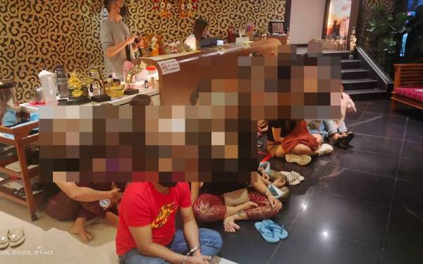 Antara pelacur warga asing dan penjaga premis yang ditahan imigresen dalam serbuan di Taman Pelangi, Johor Bahru pada Sabtu.