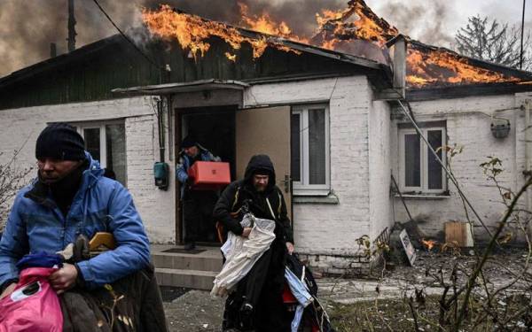 Beberapa penduduk di Kharkiv menyelamatkan barangan penting selepas kediaman mereka terbakar akibat dibedil tentera Moscow. - Foto: Agensi