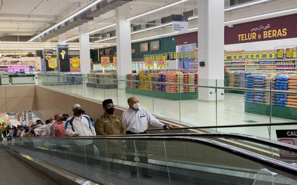 Dr Ameer (kanan) membawa tetamu jemputan melihat bahagian tingkat atas pasar raya berkenaan.
