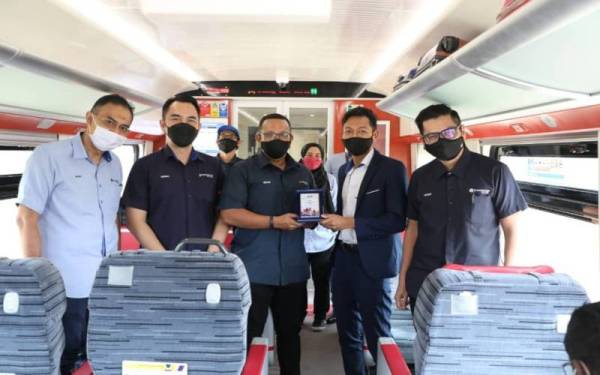 Nizam (tiga dari kiri) menyampaikan cenderamata kepada wakil KTMB sebagai tanda kerjasama buat pertama kali.