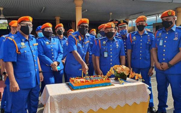 Ishak (tengah) memotong kek majlis sambutan Hari Ulang Tahun Pertahanan Awam (HUTPA) kali ke-70 di Butterworth pada Khamis.