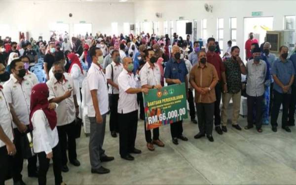 Mahdzir (enam dari kanan) selepas menyerahkan sumbangan khas persekolahan daripada Yayasan RISDA bernilai RM66,000 kepada 330 anak pekebun kecil RISDA di daerah Kuala Nerang