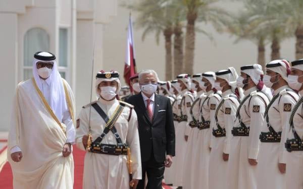 Ismail Sabri diiringi Sheikh Tamim (kiri) ketika membuat pemeriksaan kawalan kehormat Pengawal Istiadat di pekarangan Amiri Diwan, Qatar pada Selasa. - Foto Bernama