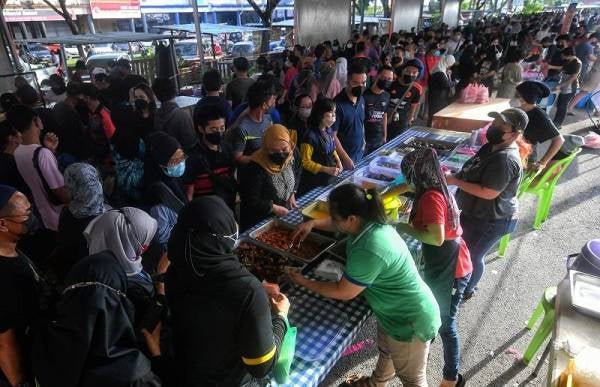 Orang ramai membeli juadah untuk berbuka puasa pada hari pertama pembukaan Bazar Ramadan di Mydin Samariang di Petra Jaya pada Ahad dengan mematuhi SOP seperti pemakaian pelitup muka.
-Foto Bernama