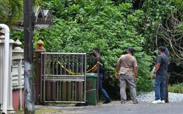 Anggota polis mengawal di luar rumah kosong selepas salah seorang suspek terbunuh dalam kejadian tembak-menembak dengan pihak polis di Kampung Simpang Tokku pada Selasa. - Foto Bernama