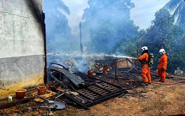 Anggota bomba berusaha memadamkan kebakaran di Felda Jengka 14 pada Selasa.