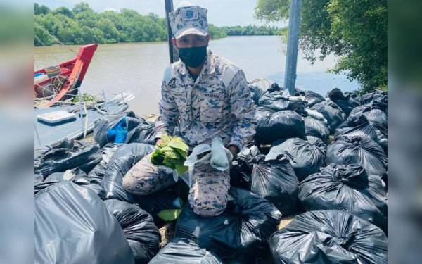 Anggota Maritim Malaysia menunjukkan daun ketum yang cuba diseludup keluar yang dirampas di kedudukan 0.2 batu nautika muara Kuala Sala, Kuala Kedah pada Khamis.