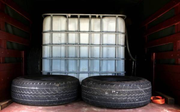 Sebuah rampasan tong berukuran besar yang berada di ruangan belakang sebuah lori secara haram yang bertujuan penyelewengan minyak diesel bersubsidi. - Foto Bernama