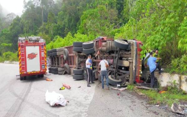 Keadaan treler yang terbabas dan terbalik di jalan lama Lipis-Merapoh, pada Selasa.