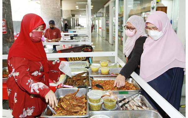 Pemilik Restoran Cafe D’Amiey melayani pelanggan yang datang membeli juadah di gerainya.