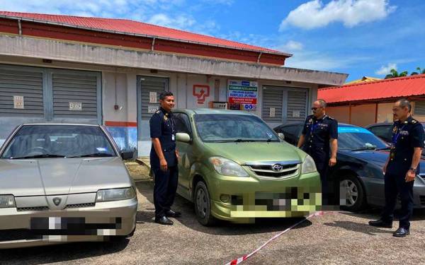 Mohd Misuari (dua dari kanan) menunjukkan sebahagian daripada kereta sapu yang ditahan anggota JPJ Kelantan menerusi Op Sapu awal pagi Khamis.