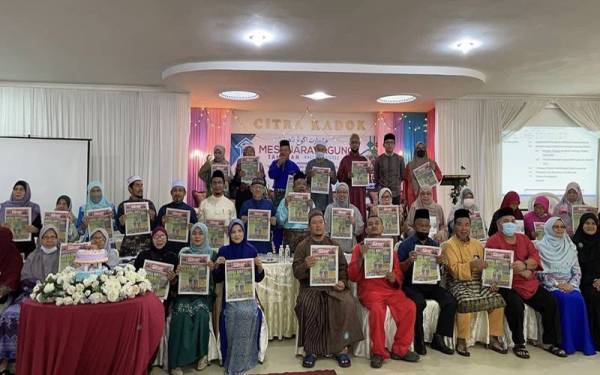 Barisan ahli Persatuan Rumah Ngaji Kelantan (PRNNK) menunjukkan akhbar Sinar Harian yang diperolehi pada Mesyuarat Agong PRNNK kali ke-3 di Kadok.