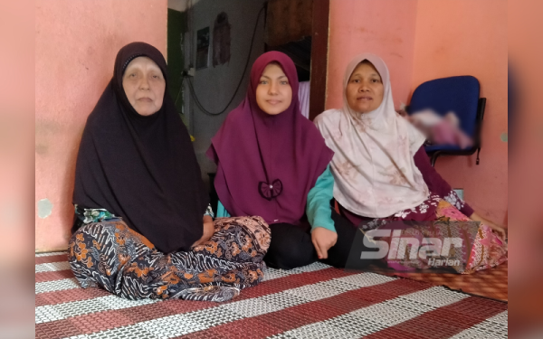 Umi Aqilah (au centre) avec Siti Eshiah et Eshah (à droite) lors de leur rencontre dans leur maison à Baling, Kedah.