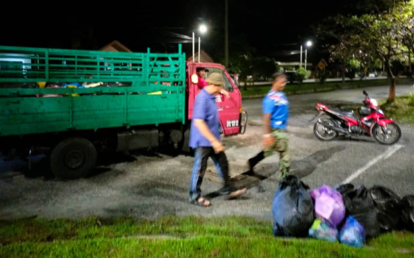Penduduk Taman Chepor Sentosa bergotong-royong mengangkut sampah yang tidak dikutip untuk dilupuskan. - Foto Ihsan Pembaca