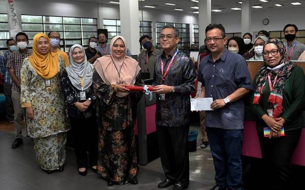 Ketua Perancangan Strategik Jabatan Pengarang Pertubuhan Berita Nasional Malaysia (Bernama) merangkap wakil Jawatankuasa Induk Hari Wartawan Nasional (HAWANA) 2022 Nur-ul Afida Kamaludin (tiga, kiri) menyerahkan cek dan deklarasi HAWANA kepada Ketua Pengarang Kumpulan Media Karangkraf Sinar Harian Rozaid Abdul Rahman (tiga, kanan) di Seksyen 15 hari ini.