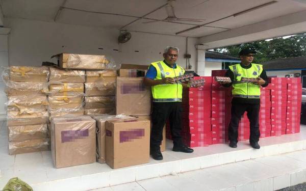 Anggota PPM Wilayah Tiga Tok Bali menunjukkan rokok seludup yang dirampas di Kampung Balai, Bachok, pada Jumaat.