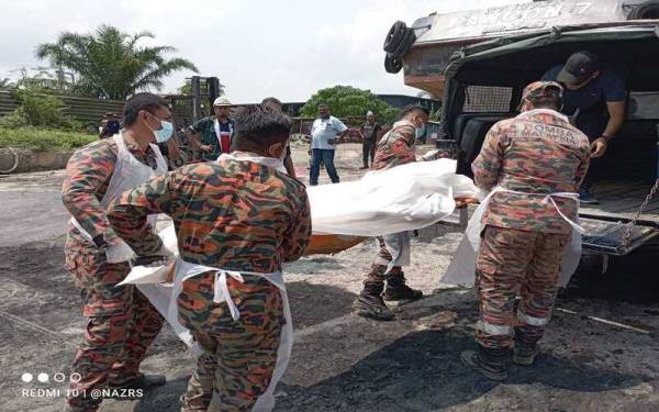 Anggota bomba mengangkat mayat nelayan yang ditemukan lemas pada Isnin.