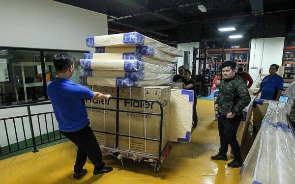 Pasukan Bantuan Bencana Istana Negara menyediakan barang keperluan untuk disumbangkan kepada mangsa banjir di Baling, Kedah. Gambar ihsan: Istana Negara