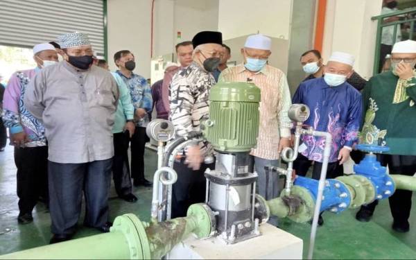 Ahmad (tiga dari kanan) mendengar penerangan daripada Dr Azuhan (empat dari kanan) berkaitan operasi LRA Tualang 2 di Kuala Krai pada Khamis.