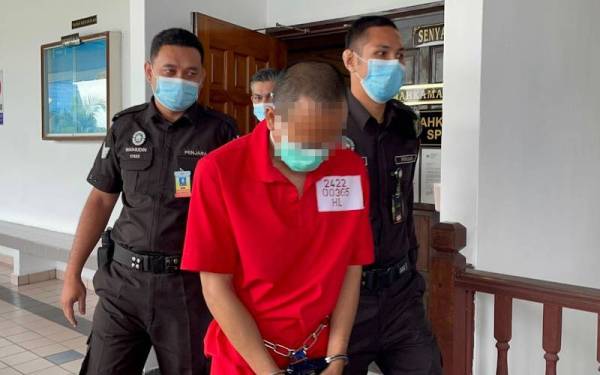 Tertuduh ketika dibawa keluar dari Mahkamah Sesyen pada Khamis.