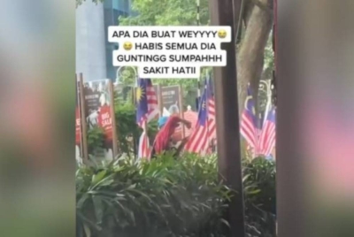 Satu video berdurasi 37 saat dalam aplikasi TikTok memaparkan seorang lelaki berbaju merah dan bertopi biru menggunting beberapa Jalur Gemilang di Jalan Ampang.
