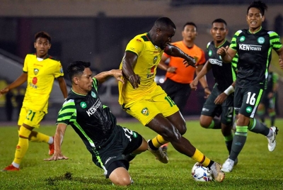 Pemain Melaka United FC cuba menghalang kemaraan pemain Kedah Darul Aman FC Wanja Ronald Ngah (tengah) ketika beraksi dalam perlawanan bola sepak Liga Super di Stadium Hang Jebat, pada Jumaat - FOTO-Bernama