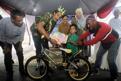 Khairy (dua dari kiri) menyampaikan hadiah kepada pemenang peraduan pada program Merdeka Parlimen Rembau di Balai Raya Kampung Kendong pada Ahad. - Foto Bernama