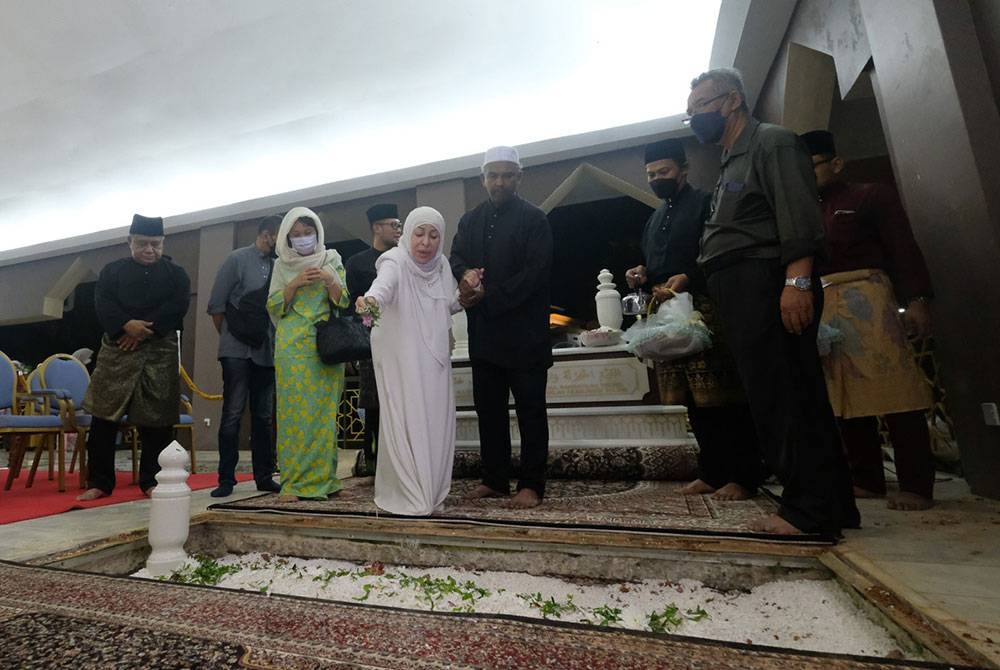 Ahli keluarga terdekat menabur bunga mawar di atas pusara Allahyarham Datuk Seri Mohd Adib Mohamad Adam selepas selamat disemadikan di Makam Pahlawan Masjid Al-Azim Bukit Palah hari ini.