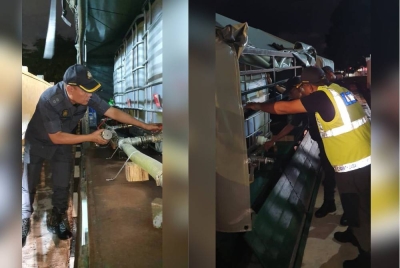 Anggota KPDNHEP Pulau Pinang sedang memeriksa lori yang dirampas daripada suspek.