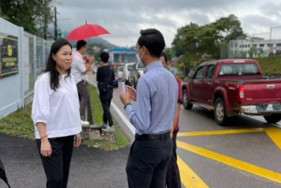 Shu Qi (kiri) ketika melawat projek pelebaran simpang jalan di Kampung Melayu, Kluang pada Rabu.