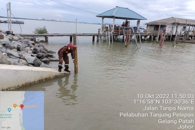Anggota bomba melakukan pemantauan sekitar pintu air JPS di Tanjung Piai pada Isnin.