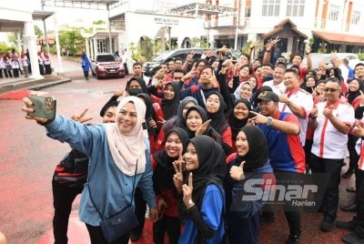 Noraini bergambar bersama pelajar pada program KPT Prihatin dan Majlis Penyerahan Peranti Siswa Keluarga Malaysia di UMK Kampus Kota, Pengkalan Chepa pada Jumaat.
