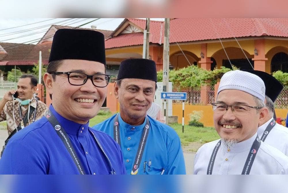 Khairul Azwan (kiri) beramah mesra dengan calon Pakatan Harapan Parlimen Pasir Salak, Nik Omar Nik Abdul Aziz (kanan) di pusat penamaan calon di Kampung Gajah.