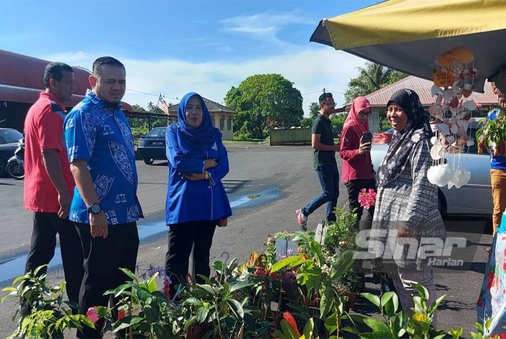 Fathul Bari (kiri) bertemu peniaga di pasar pagi Utan Aji, Kangar pada Selasa.