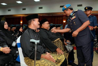 Mohd Asghar Khan (kanan) memakaikan pingat kepada veteran tentera, Shahidan Man, 71, pada Majlis Penganugerahan Pingat Jasa Malaysia (PJM) kepada Veteran ATM di Kolej Tentera Udara Alor Setar pada Khamis. - Foto Bernama