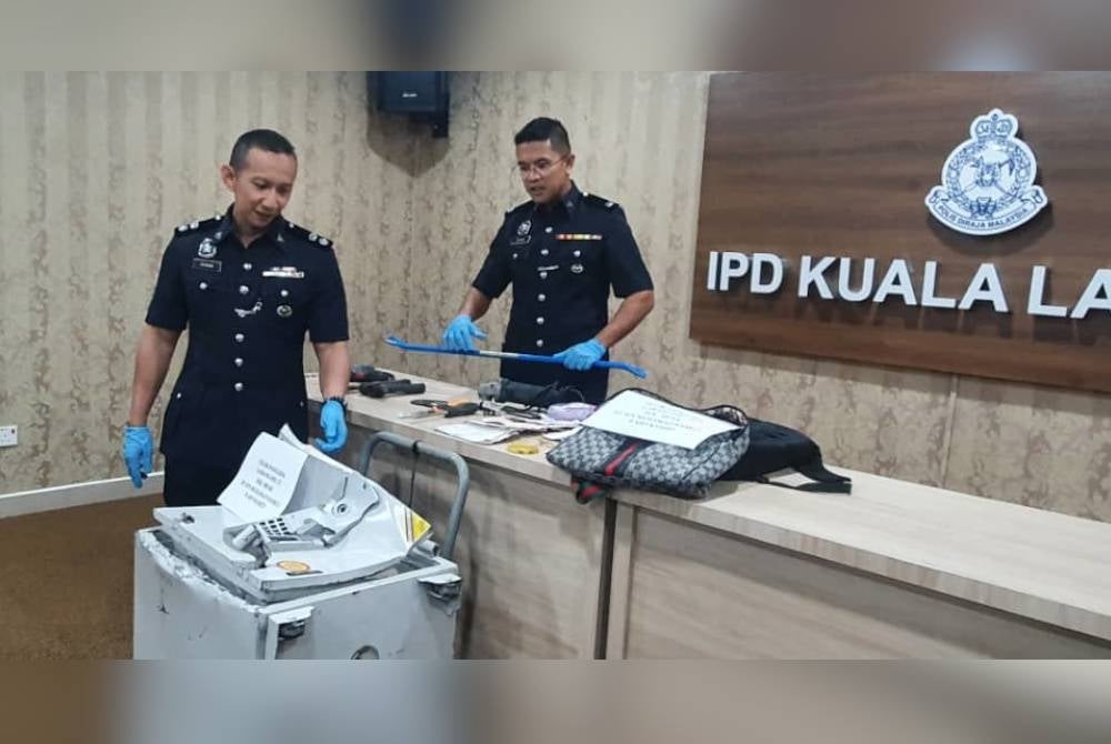 Ahmad Rihdwan (kiri) menunjukkan barangan yang dirampas. - Foto PDRM