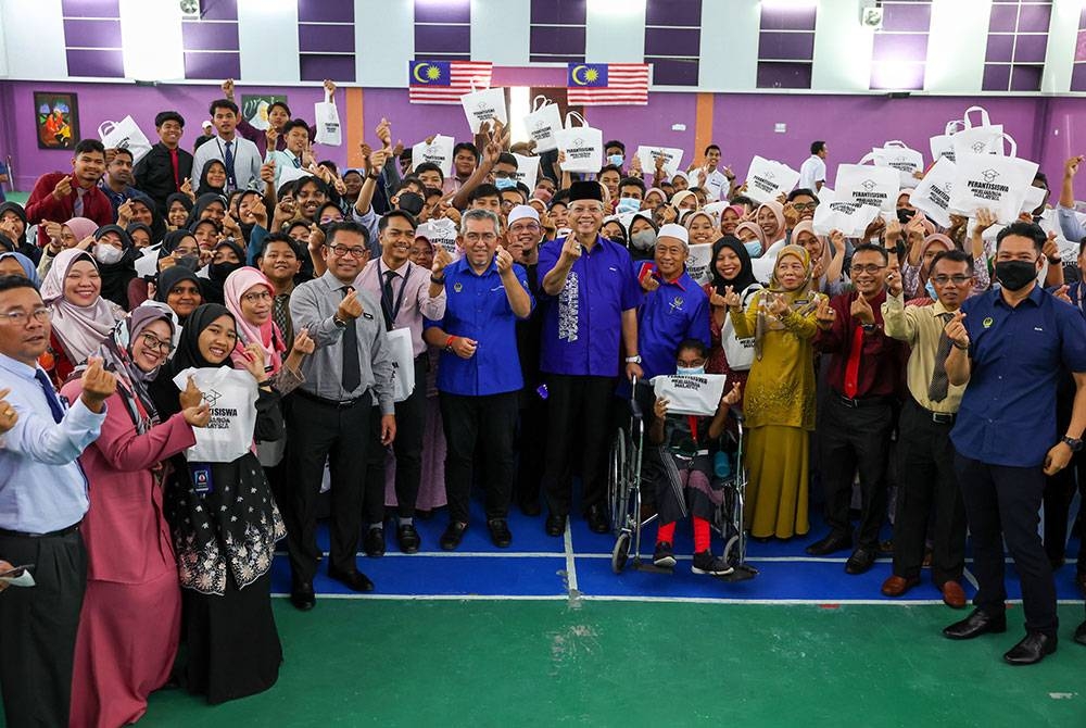 Annuar (tengah) bersama pelajar Tingkatan Enam dalam Daerah Bagan Datuk yang menerima Peranti Siswa Keluarga Malaysia di Sekolah Menengah Kebangsaan Tun Abdul Razak (STAR) Selekoh, Bagan Datuk pada Selasa. - Foto Bernama