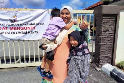 Ismaniza membawa dua anaknya bersama membuang undi di SK Meru Raya di sini pada Sabtu.