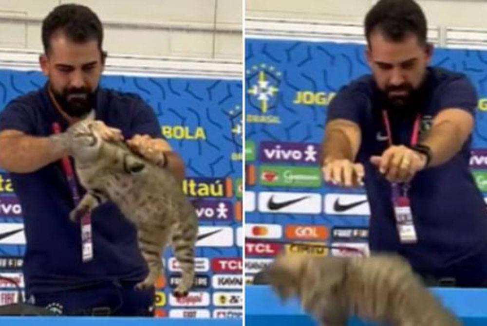 Petugas media Brazil melempar seekor kucing ke lantai ketika sidang media.