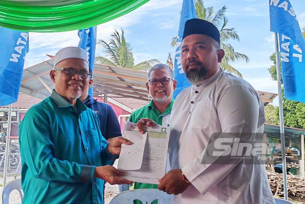 Zool Amali (kanan) menyerahkan borang keahlian Pas kepada Rafiei.