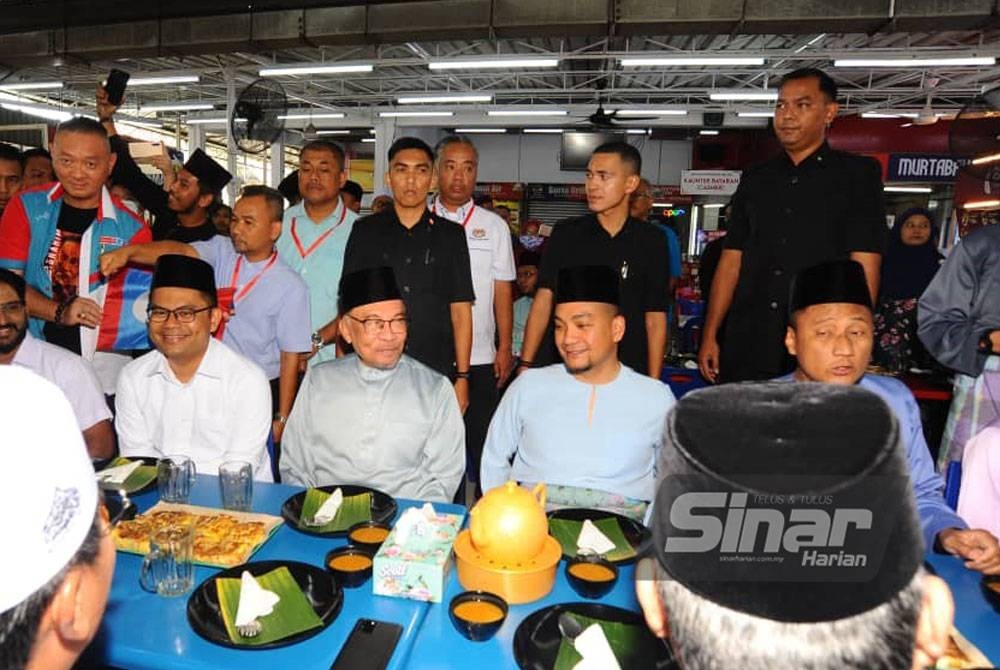 Akmal Nasrullah (duduk, tiga dari kiri) pada majlis makan tengah hari bersama Perdana Menteri, Datuk Seri Anwar Ibrahim di Kampung Melayu Majidee, pada Jumaat.