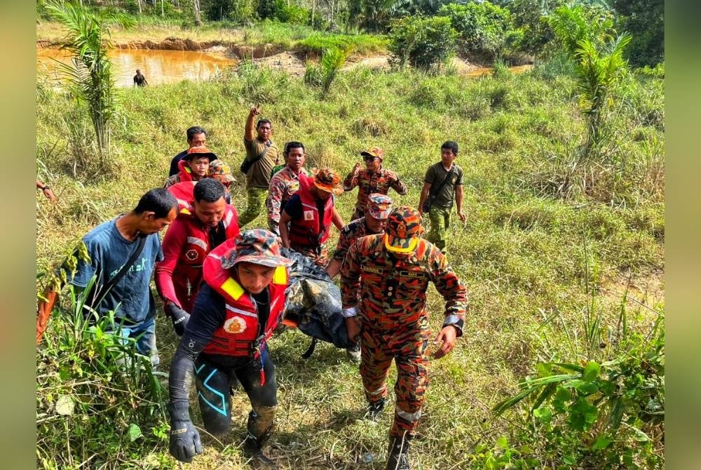 Anggota penyelamat membawa keluar mayat mangsa yang ditemui pada jam 3.55 petang pada Ahad. - Foto JBPM