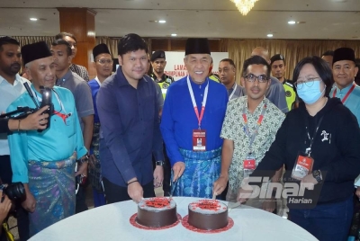 Ahmad Zahid bersama beberapa petugas media memotong kek hari jadi ketika melawat laman media pada Perhimpunan Agung UMNO 2022. - Foto Sinar Harian/ROSLI TALIB