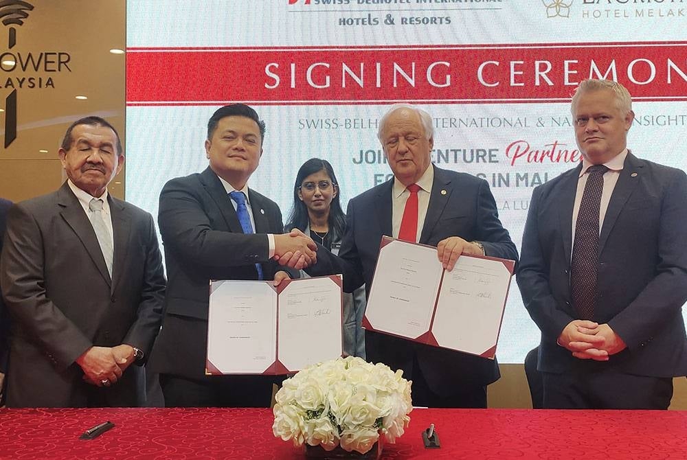 Rosthman (dua dari kiri) bersalaman dengan Gavin selepas menandatangani Perjanjian Induk (HOA) antara NISB dengan SBI di Menara Kuala Lumpur pada Selasa.