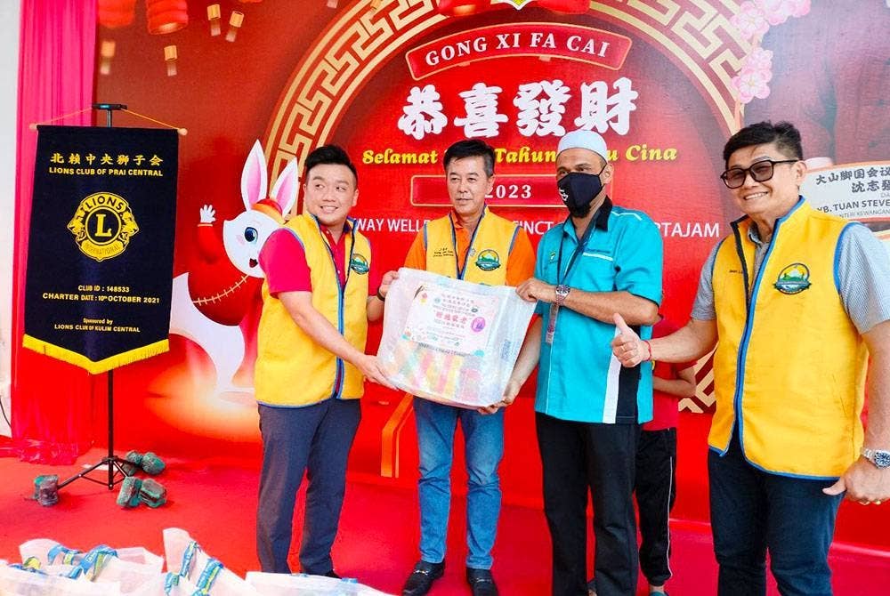 Zeon Cheong (kiri) menyerahkan bantuan bakul makanan kepada wakil penerima.