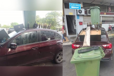 Cermin bahagian penumpang diconteng perkataan 'no parking' menggunakan cat hitam. Tong sampah dan beberapa botol arak diletakkan di atas kereta mangsa. - Foto: PDRM