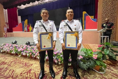 Mohammad Rizwan (kanan) dan Mohammad Najmi sijil Penghargaan Khas daripada Timbalan Ketua Polis Negara, Tan Sri Razarudin Husain.