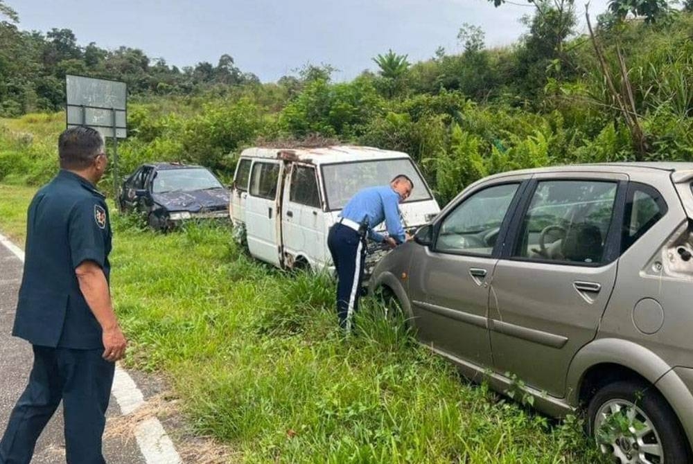 Penguat kuasa MBS memeriksa kereta yang dibiarkan tersadai di Jalan Lama Bukit Putus. Foto: Facebook MBS